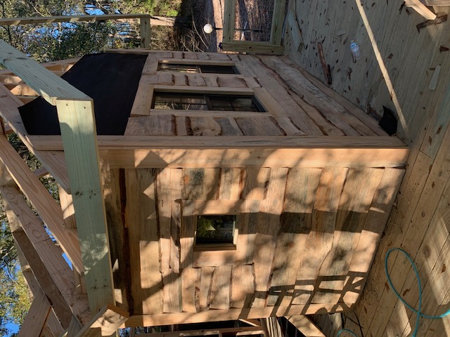 Custom framed structure with rustic board siding and gable accent
