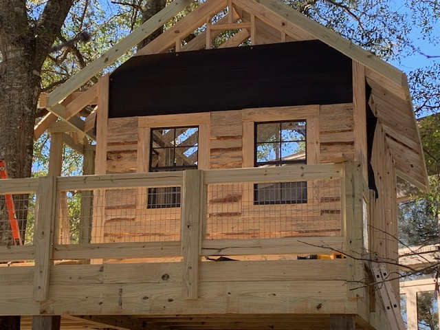 Elevated structure facade with rough-sawn board siding