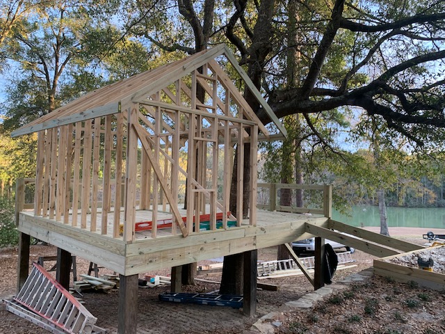 Framed structure on stilt-deck posts overlooking a lake