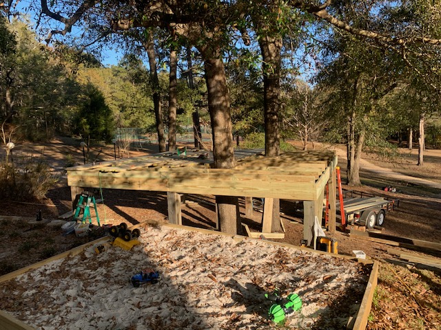 Elevated deck platform under construction among trees