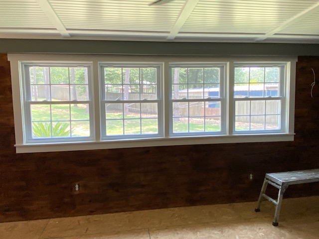 Sunroom addition with beadboard ceiling and large windows