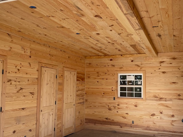 Finished pine-paneled room with closet doors and window