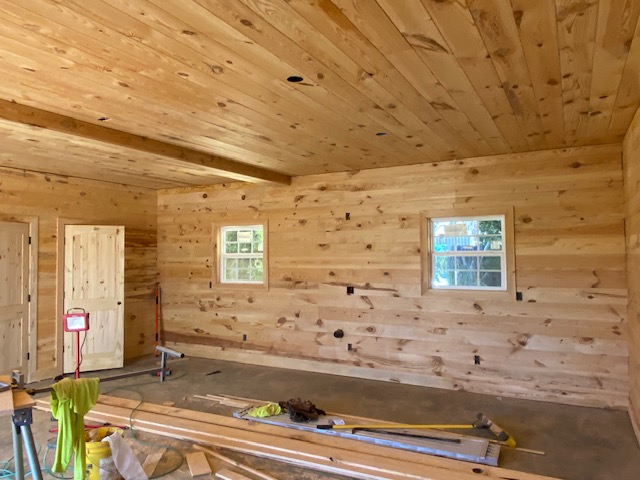 Pine-paneled room addition mid-finish, two windows