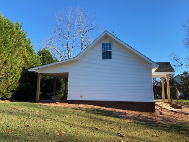 Finished home exterior with new carport and brick skirting