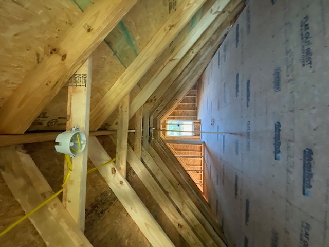 Attic roof trusses with insulation baffles by RRemodeling LLC