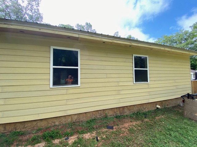 New pale-yellow lap siding installed on a home exterior in Dothan, AL