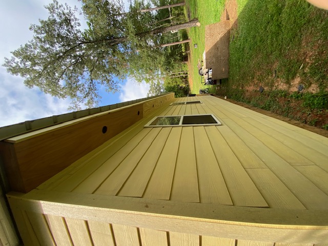 Yellow lap siding corner detail with window and soffit